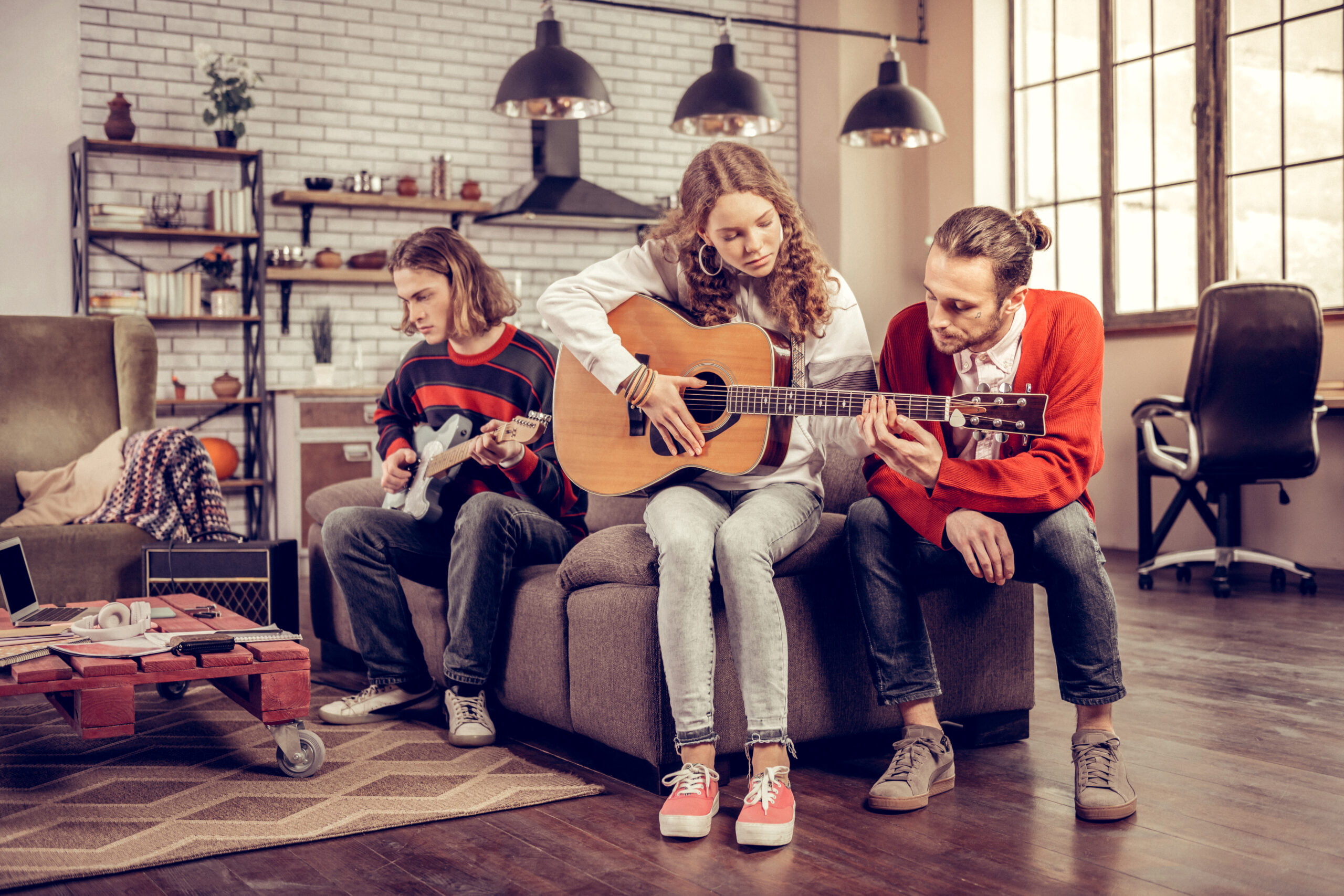 Family playing music in a modern living room with hardwood flooring